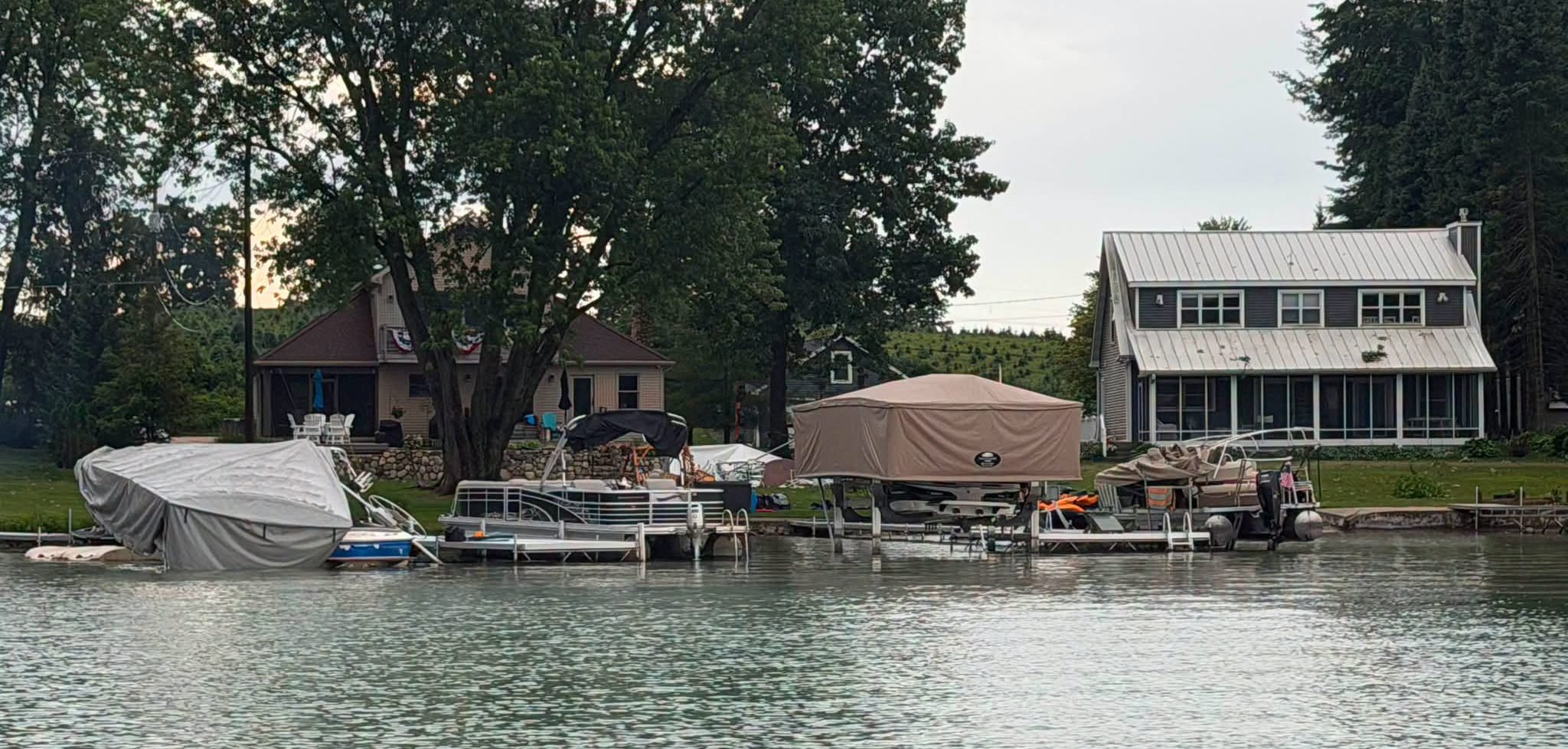 Touchless Cover® standing among storm-damaged boat lifts and boats near Sister Lakes, Michigan.