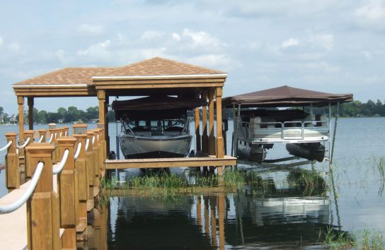 Two Touchless Boat Covers installed side by side, protecting deck boats