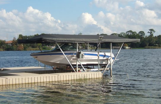 Ski boat with automatic cover docked at marina