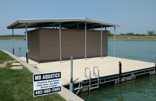 Pontoon boat protected under Touchless Boat Cover outdoors