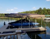 Ski boat with automatic cover docked under canopy