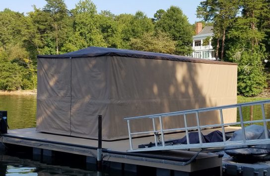 Dock sheltering boat with Touchless Automatic Boat Cover