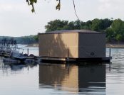 Boat secured to a dock with an automatic cover for extra shelter.