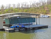 Green Touchless Pontoon Boat Cover in lowered position