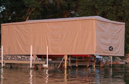 Dock with Touchless Automatic Boat Cover offering protection for a ski boat.